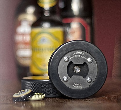 Hockey Puck Opener with bottle caps displayed in front of beer bottles