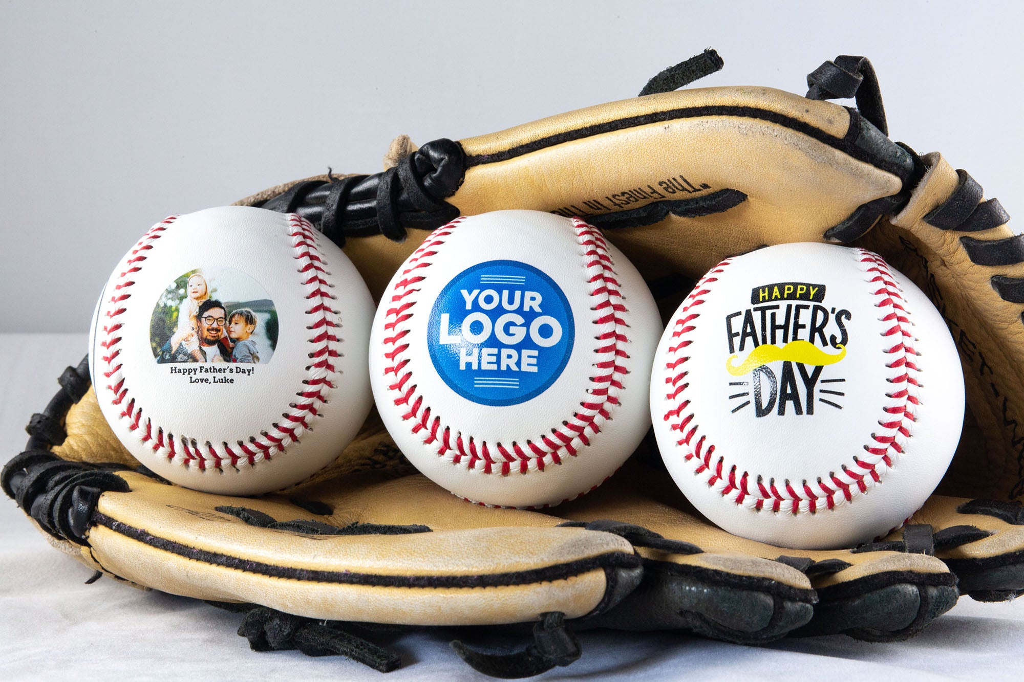 Three Printed Baseballs in Glove